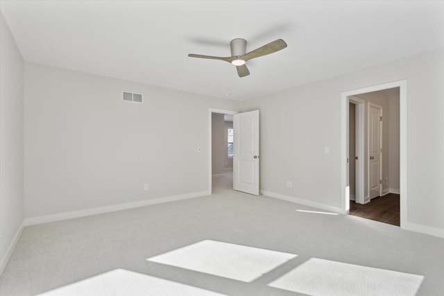 unfurnished bedroom with a ceiling fan, carpet, visible vents, and baseboards