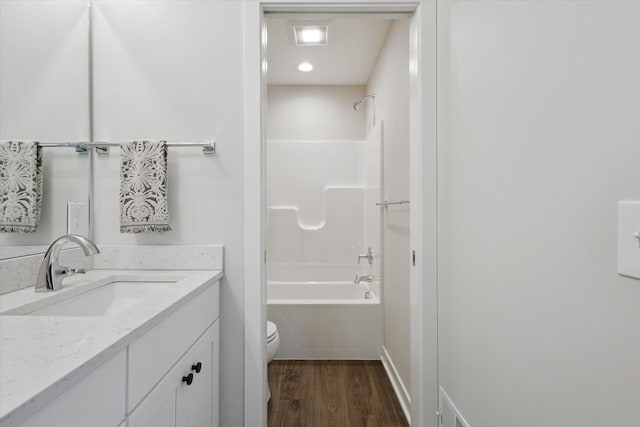 full bathroom with toilet, vanity, wood finished floors, and bathing tub / shower combination