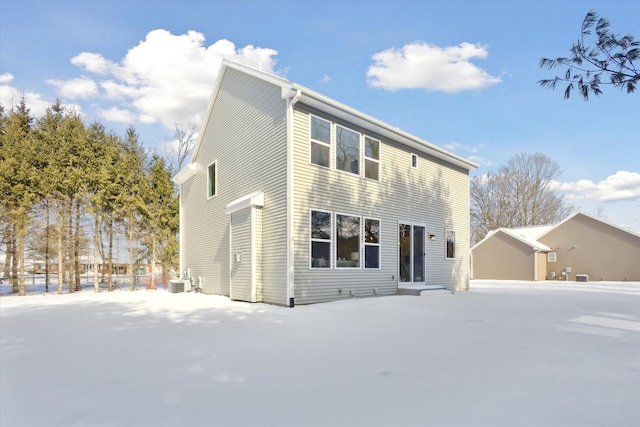 view of front of property with a detached garage and cooling unit