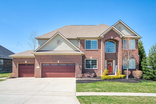 view of front facade with a garage, brick siding, a front yard, and driveway