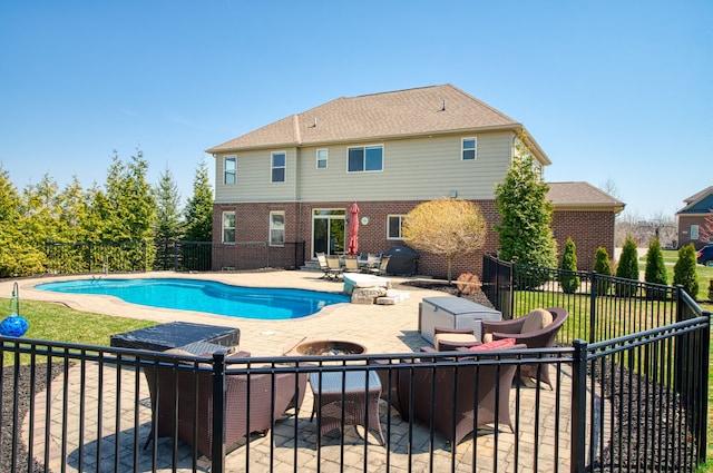 view of swimming pool featuring fence, a fenced in pool, a patio, and an outdoor fire pit