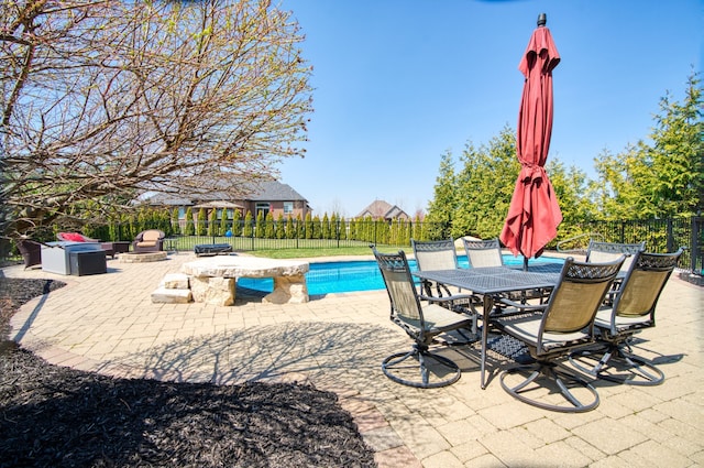 view of swimming pool featuring outdoor dining area, fence, a patio area, and a fenced in pool