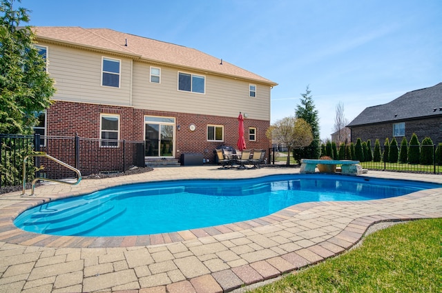 view of swimming pool with a patio area, a fenced in pool, and fence