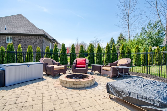 view of patio featuring fence and an outdoor living space with a fire pit