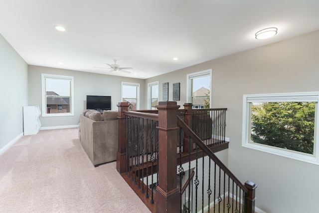 living room with recessed lighting, baseboards, and light carpet