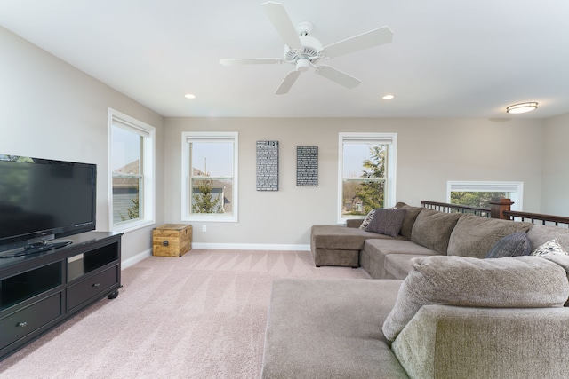 living area featuring recessed lighting, a ceiling fan, baseboards, and light colored carpet