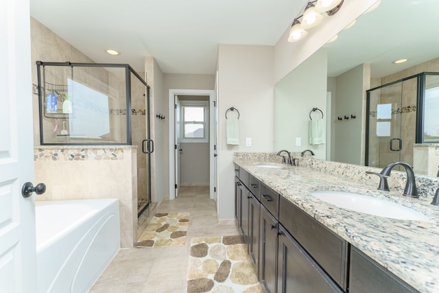 bathroom featuring a bath, a sink, and a stall shower