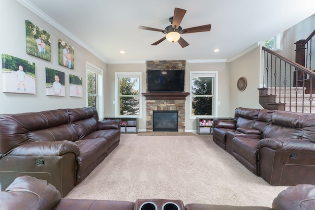 living room featuring carpet, ornamental molding, and a healthy amount of sunlight