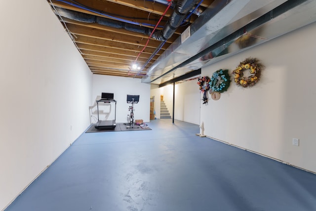 unfinished below grade area featuring stairs