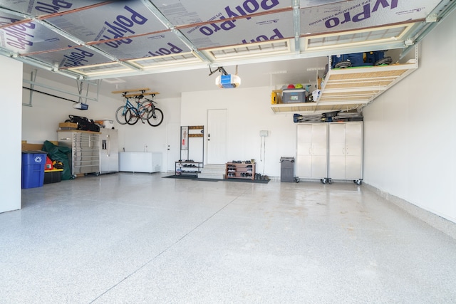 garage with stainless steel fridge with ice dispenser