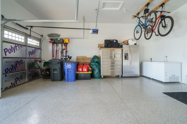 garage with refrigerator and stainless steel fridge with ice dispenser