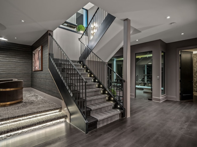 staircase featuring wood-type flooring