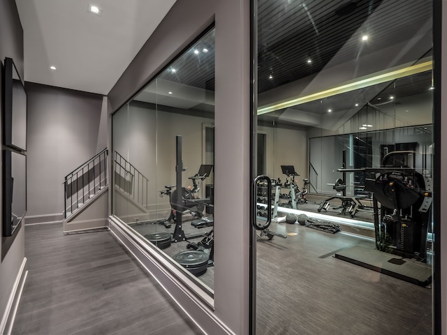 exercise room with wood-type flooring