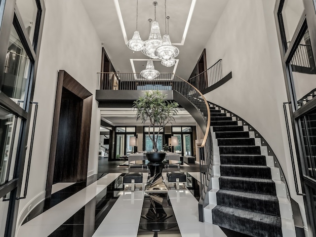 entrance foyer featuring a towering ceiling and an inviting chandelier