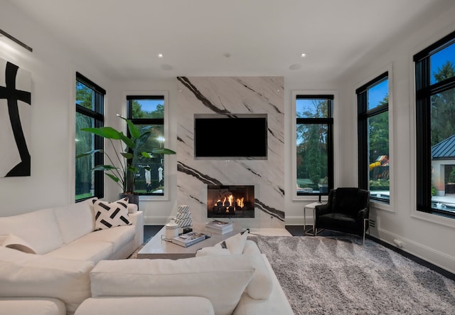 living room with a high end fireplace