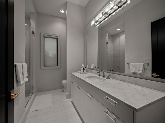 bathroom featuring tile patterned flooring, vanity, toilet, and walk in shower