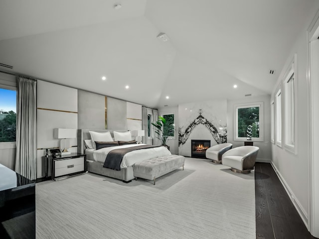 bedroom featuring light hardwood / wood-style flooring and vaulted ceiling