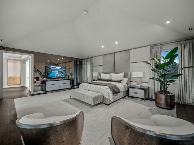 bedroom featuring light hardwood / wood-style floors and vaulted ceiling