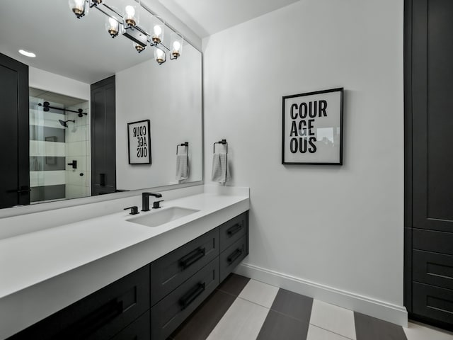 bathroom featuring a tile shower and vanity