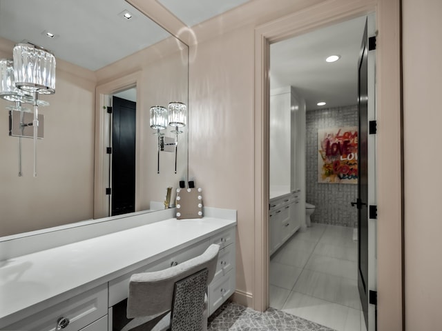 bathroom with toilet, vanity, a chandelier, and tile patterned floors