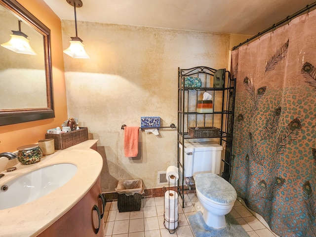 bathroom featuring tile patterned floors, vanity, and toilet