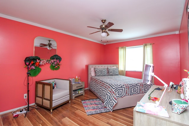 bedroom featuring ceiling fan, wood-type flooring, and ornamental molding