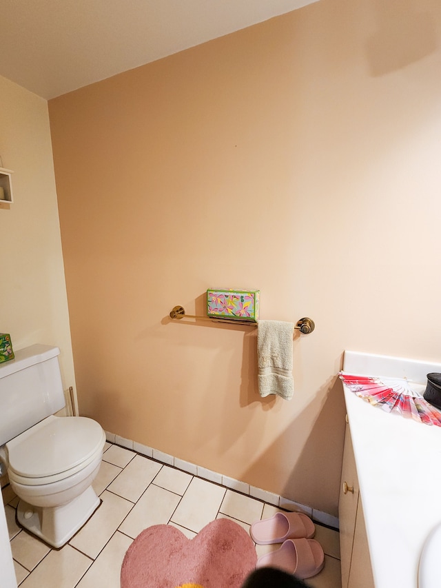 bathroom featuring tile patterned floors, vanity, and toilet