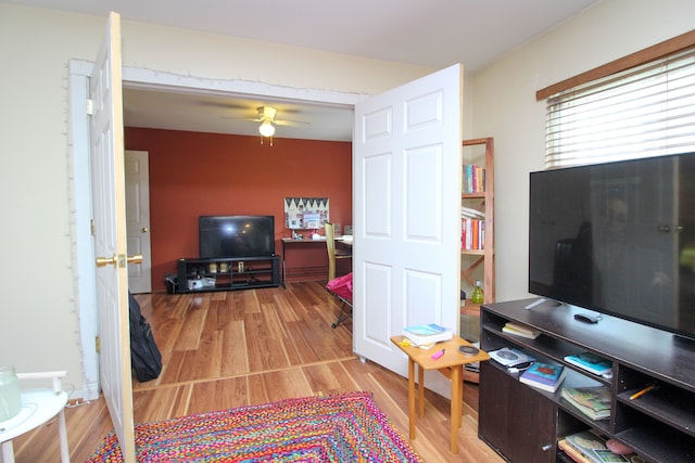 living room featuring light wood-type flooring and ceiling fan