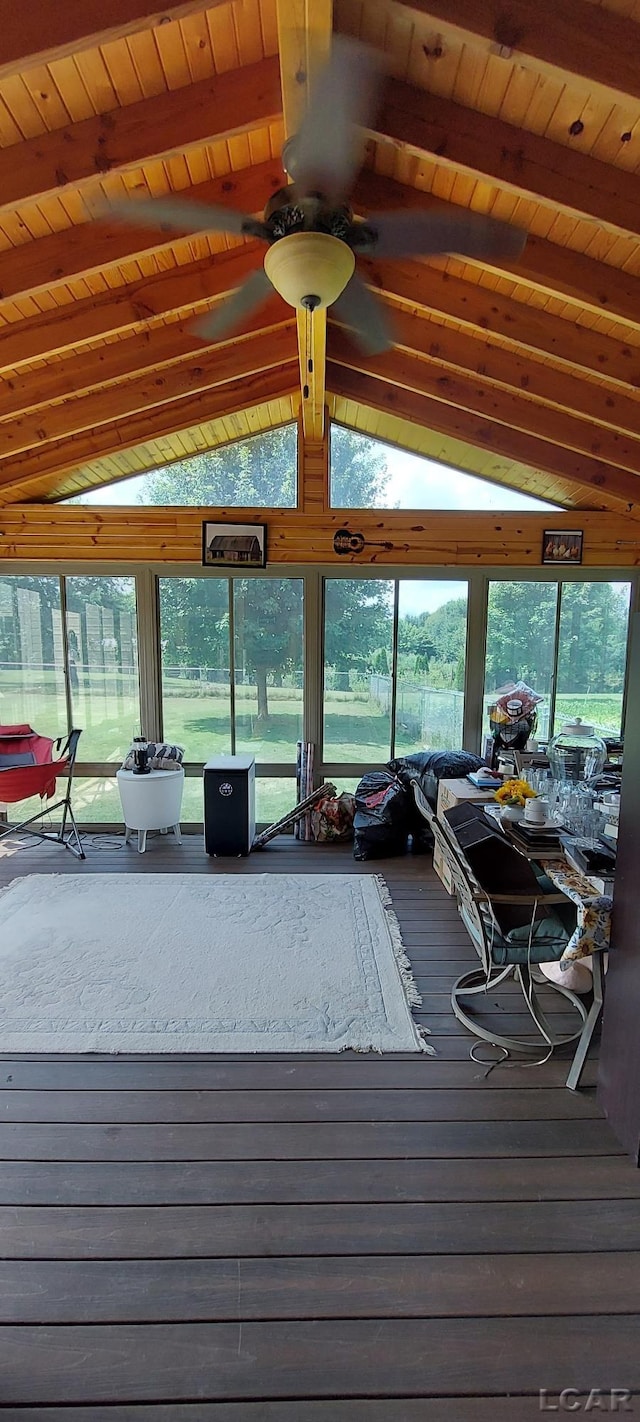 unfurnished sunroom featuring lofted ceiling with beams, ceiling fan, and wooden ceiling