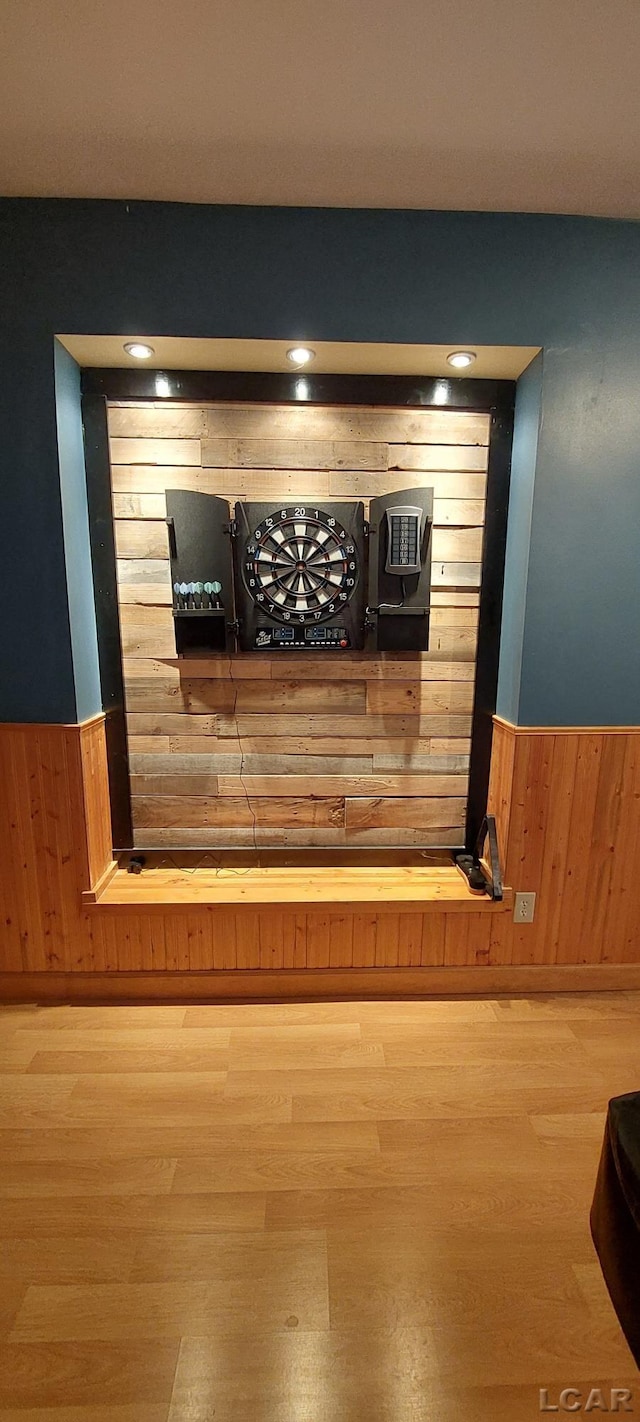 interior details featuring wood walls and hardwood / wood-style floors