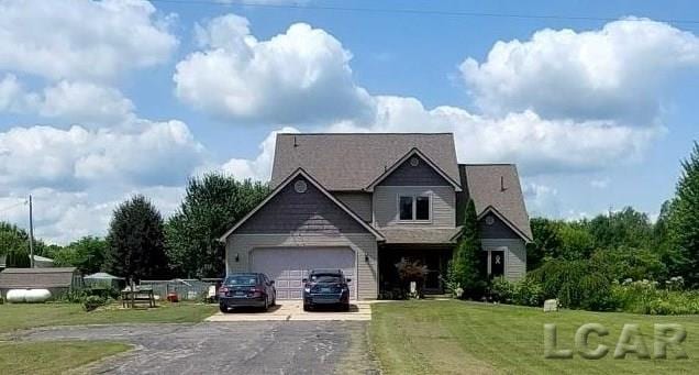 view of front of home featuring a front yard and a garage