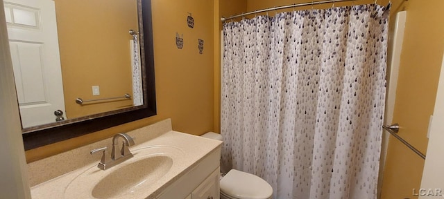 bathroom featuring vanity, toilet, and walk in shower