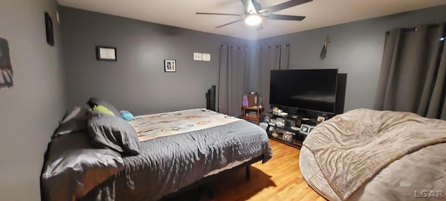 bedroom featuring hardwood / wood-style flooring and ceiling fan