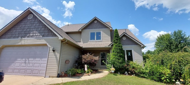 view of front of home with a front yard and a garage