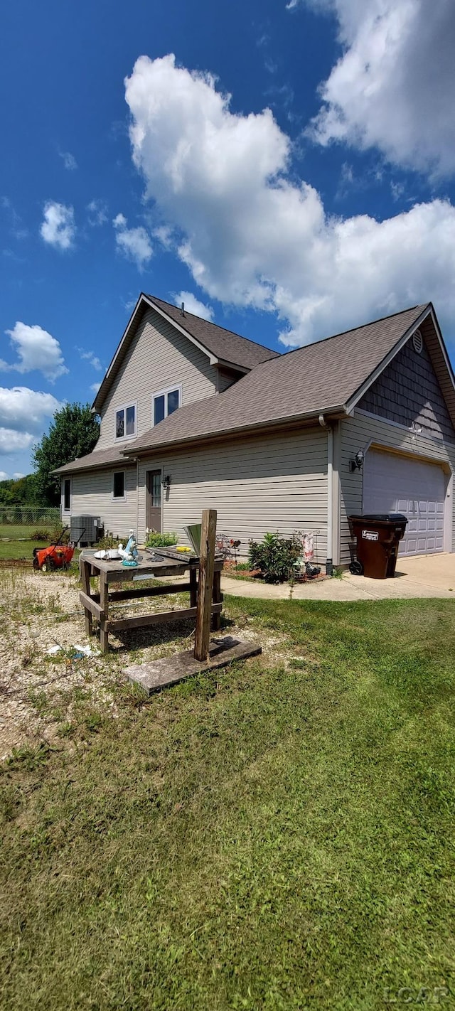 view of home's exterior featuring a lawn and a garage