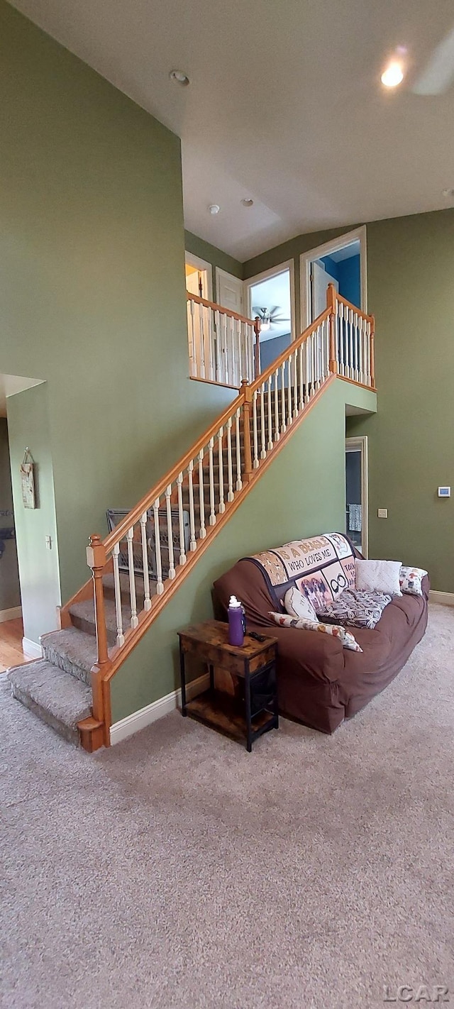 carpeted living room featuring ceiling fan