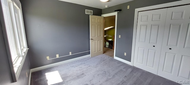 unfurnished bedroom with a closet and carpet