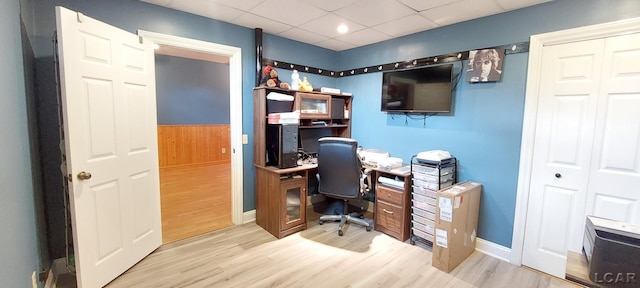 office area with hardwood / wood-style floors and a drop ceiling