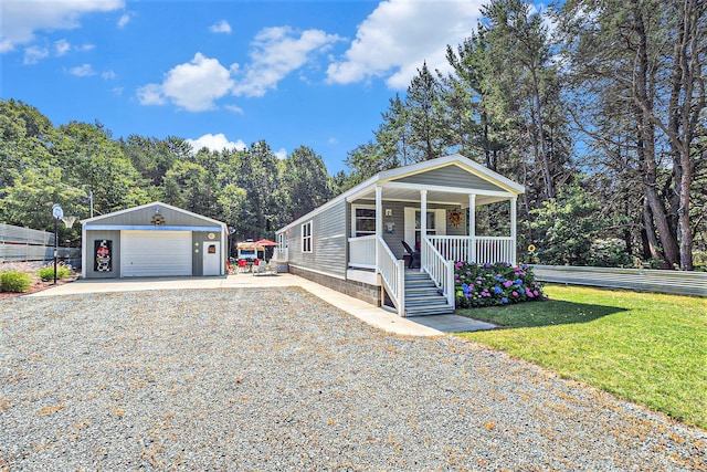 view of front facade with a front lawn, covered porch, an outdoor structure, and a garage