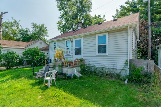 back of house with a lawn