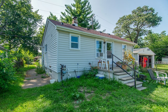 view of front of property with cooling unit and a front yard