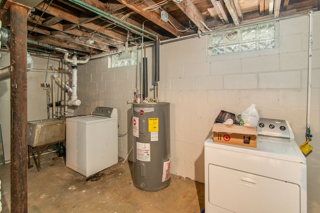 basement featuring washing machine and dryer, electric water heater, and sink