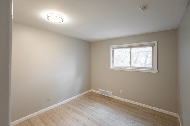 spare room with light hardwood / wood-style floors