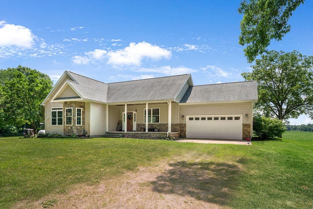 ranch-style home featuring covered porch, a garage, and a front yard