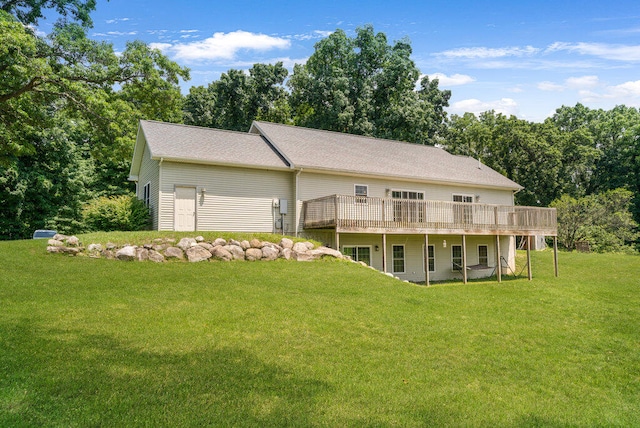 view of front facade with a wooden deck and a front yard