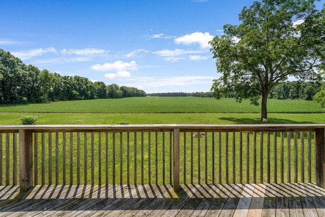 deck with a yard and a rural view