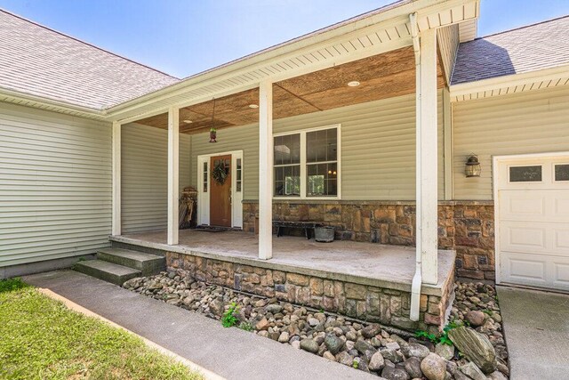 23381 Fosdick St, Dowagiac, MI 49047 - property entrance with a shingled roof, covered porch, and stone siding