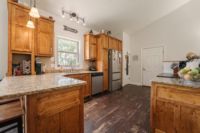 kitchen with dark hardwood / wood-style flooring, stainless steel appliances, vaulted ceiling, sink, and hanging light fixtures