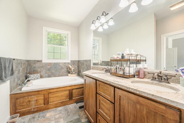 23381 Fosdick St, Dowagiac, MI 49047 - bathroom with double vanity, a bath, and stone finish flooring