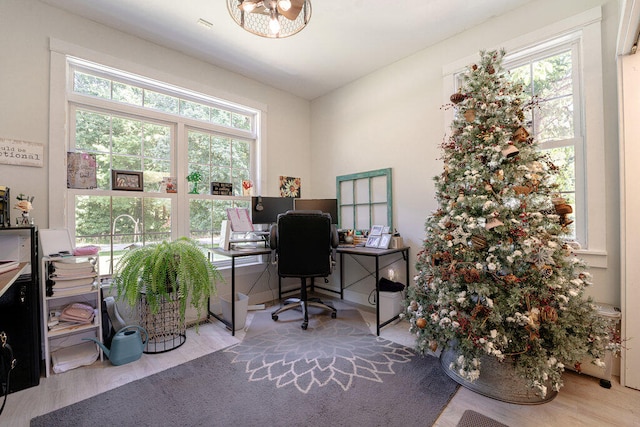 home office with a healthy amount of sunlight and light wood-type flooring